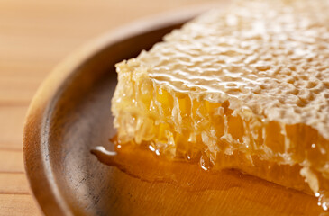 Macro Shot of Golden Organic Honeycomb on a Wooden Plate - Pure Raw Honey Texture