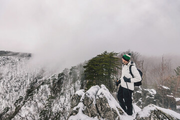 Man Hiking in Mountain Landscape with Winter Fog