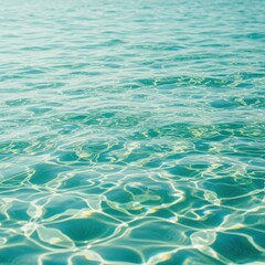 Obraz premium Clear turquoise water surface with sunlight reflections and ripples serene aquatic scene natural beauty