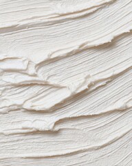 Textured background of white cream or frosting with wavy brush strokes. Organic skincare product or delicious dessert spread concept. Cloud dancer color