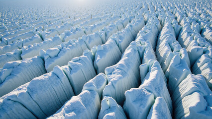 Majestic ice formations create stunning landscape of ridges and valleys, showcasing beauty of nature frozen artistry