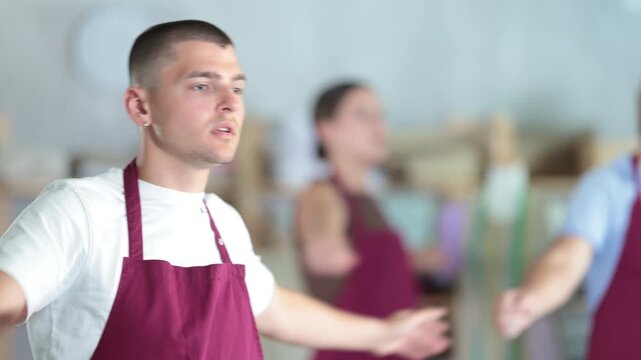 Sewing workshop employees do warm-up exercises, compensate for lack of movement. Prevention of consequences of sedentary lifestyle.