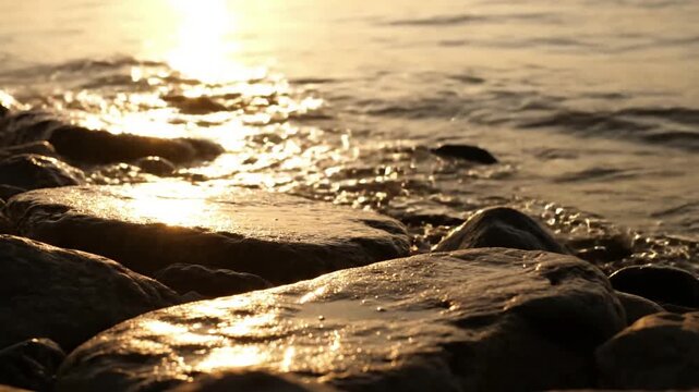 River current flowing past sunlit riprap Mid-shot, showing gentle water movement and the play of light across a section of riprap.