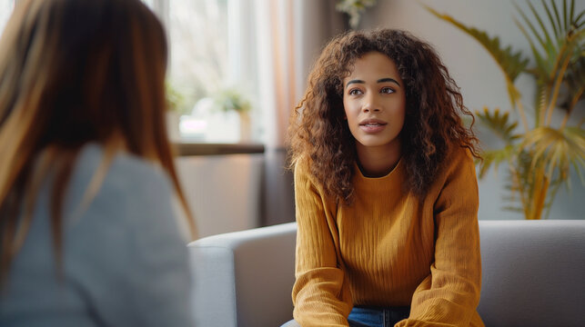 Therapy session: young woman talks with counselor in cozy office, seeking mental health support and guidance. Psychotherapy concept, empathy, communication, wellness, professional counseling.