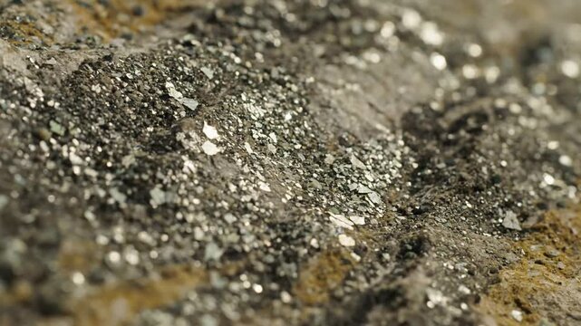 Schist Texture and Luster Slow, subtle camera movement revealing the layered texture of schist with embedded sparkling mica particles.