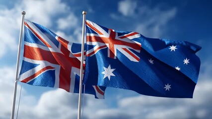 Flags of Australia and the United Kingdom waving in the wind against a blue sky