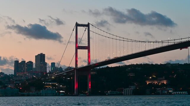 Istanbul,turkey,august 4, 2025. Famous 15 july martyrs bridge illuminated with red lights connecting the european and asian sides of istanbul over the bosphorus strait