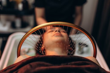 Woman enjoying head spa water massage for scalp care