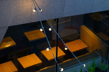 small cozy cafe indoor space warm light design and garland decorative low key dusk condition top view foreshortening pattern urban style objects