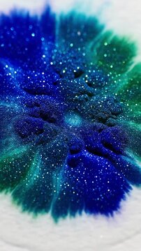 Dynamic Sparkle Trails in Spreading Ink Footage capturing the fluid motion of ink spreading on a wet surface, highlighting shimmering trails and patches as the granulation process begins.