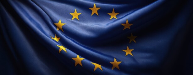 The European Union flag waving on silky blue fabric with golden stars