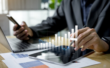 Businessman investment consultant analyzing company financial report and balance sheet, reviewing digital graphs and charts for stock market analysis, finance, tax, and project planning.