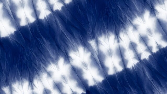 Diagonal indigo blue and white tie dye stripes. Textured shibori fabric and minimalist aesthetic background. Crinkled cloth with blurred geometric patterns for textile design.