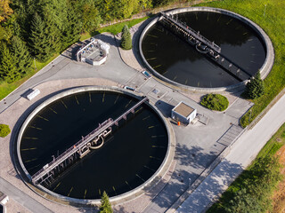 Drone captures aerial view of advanced wastewater treatment plant focusing on water purification and sustainable infrastructure.