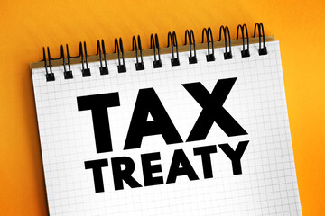 Tax Treaty - bilateral agreement made by two countries to resolve issues involving double taxation, text concept on notepad