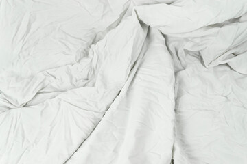 A close-up of white linen, showing the detailed texture and elegant folds of the fabric, its wavy...