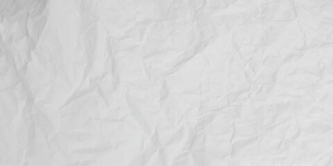 Obraz premium Close-up macro view of a wrinkled white paper surface, A high-angle view of a sheet of white paper, crumpled and wrinkled into an intricate, abstract texture. Perfect for backgrounds, mockups.