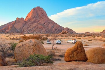 Rock formation, Spitzkoppe Mountain National Park, Namibia, cars in wild campeground area © Tunatura
