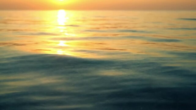 Subsurface Sunbeams Show the dancing, dappled light patterns created by sun reflection and refraction on the sandy seabed or underwater objects, viewed from just below the surface.