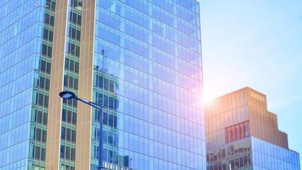 Fototapeta premium Modern office building exterior made from glass and steel. Windows of office building. Abstract architectural concept with sunlight. 