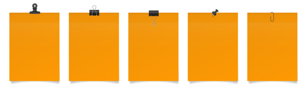 Set of large paper notes with binder clips, bulldog clip, paper clip and push pin. Orange sheets of paper. Black holders	