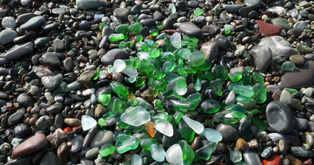 Glass sea pebbles of different colours on shore, beach. Nature and ecology. Background for design.