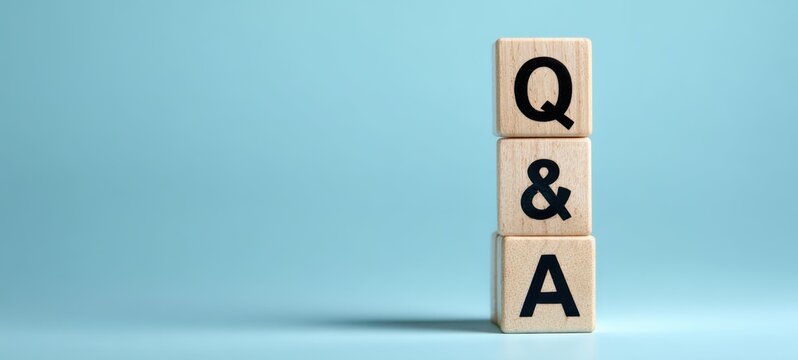 The Q&A wooden blocks representing questions and answers concept on blue background - Powered by Adobe