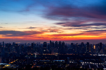 Bangkok city skyline at dawn, dramatic sky, urban metropolis, Thailand
