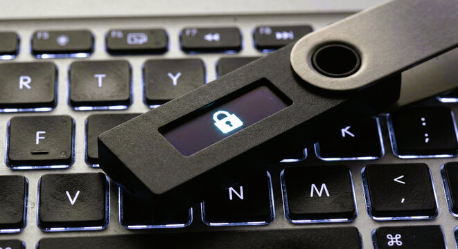 Hardware Cryptocurrency Wallet on Laptop Keyboard with Lock