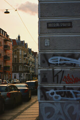 European street golden hour sunset buildings parked cars urban Poland warm