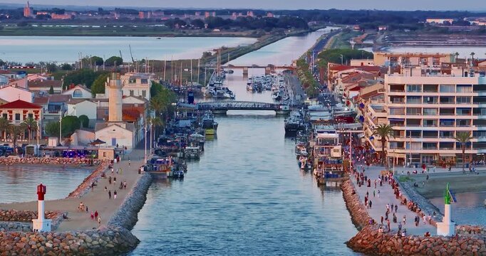 Aerial view of the Grau du Roi fishing village at sunrise in Camargue, a resort on the coast of Occitanie region in France. Beautiful coast town Grau du Roi in southern France