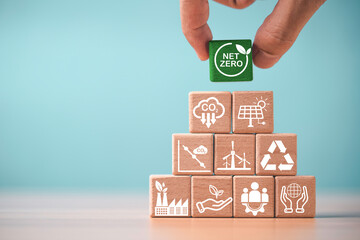 Net zero and ESG strategy concept with wooden blocks and sustainability icons representing carbon...
