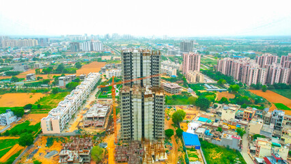 Naklejka premium under construction building with crane and metal rebar sticking out showing rapid development on the outskirts of delhi, mumbai, hyderabad, cochin, bangalore