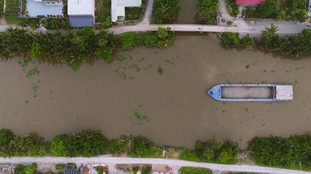 Aerial Drone View of Sand Carrier Ship Transporting Raw Materials on River in Vietnam
The vessel is heavily loaded with dredged sand, destined for local construction and infrastructure projects