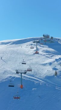Jahorina, Bosnia and Herzegovina &ndash; January 17, 2026: Drone circles Ogorjelica II gondola capturing ski resort summit and surrounding slopes