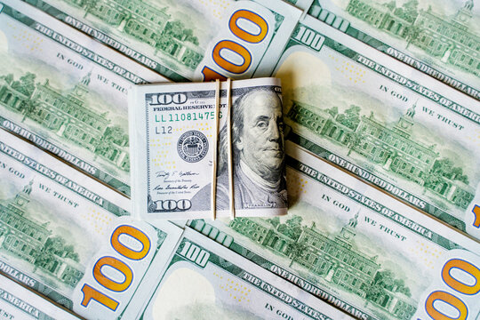 American bills in denominations of 100 US dollars are laid out on the surface and occupy the entire area of ​​the image, the background is made of American dollars, greenbacks of large denominations, 