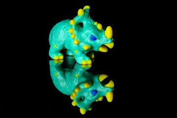 Toy Dinosaur Chasmosaurus on a black glass background © nedomacki