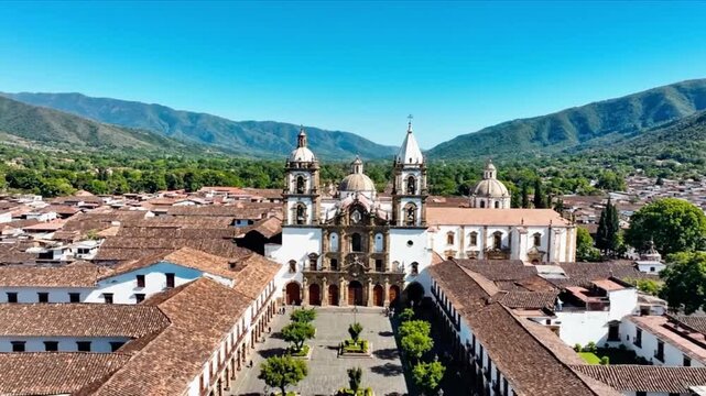 Aerial static footage of popayan cathedral and historic central square nestled between lush green mountains colombia