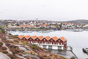 Fototapeta premium Colorful seaside village of Smogen in Vastra Gotaland, Sweden with red houses and boats
