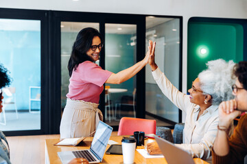 Coworkers high-fiving after a win
