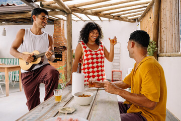Friends enjoying samba music and drinks in Rio de Janeiro backyard
