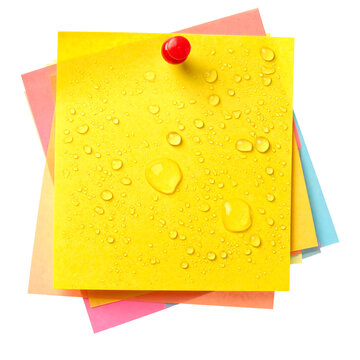 Yellow sticky note with realistic water droplets and red push pin on stack of colorful memo pads, isolated on white background, waterproof concept for office and outdoor tasks