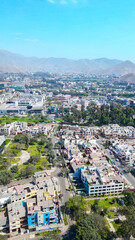 Drone view of La Molina with green areas and urban neighborhoods.