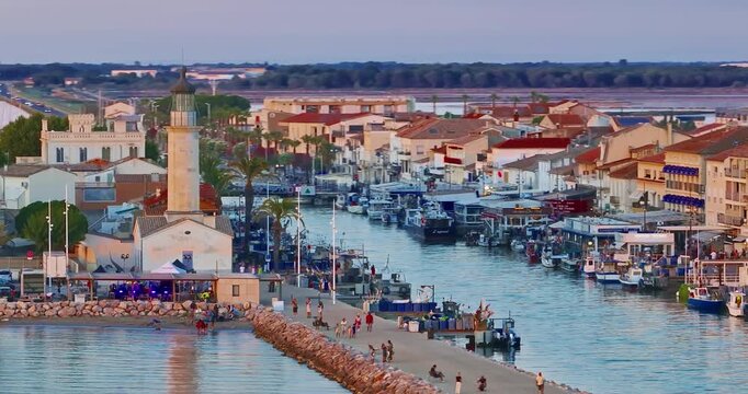 Aerial view of the Grau du Roi fishing village at sunrise in Camargue, a resort on the coast of Occitanie region in France. Beautiful coast town Grau du Roi in southern France