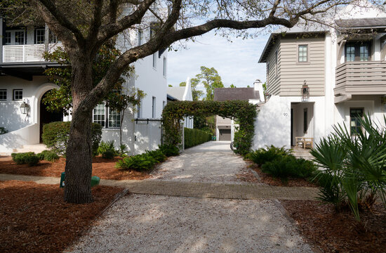 Rosemary Beach, Florida, USA &ndash; January 2026: Pedestrian walkway between residential homes with landscaped gardens in the coastal community of Rosemary Beach along Scenic Highway 30A.