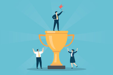 Businessman holding a red flag on top of a giant gold trophy with a male and female coworker cheering below, symbolizing team achievement and victory.