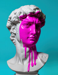Classical white sculpture bust featuring calm stoic male face covered in bright pink liquid paint dripping down neck against cyan background showing modern creative abstract art concept