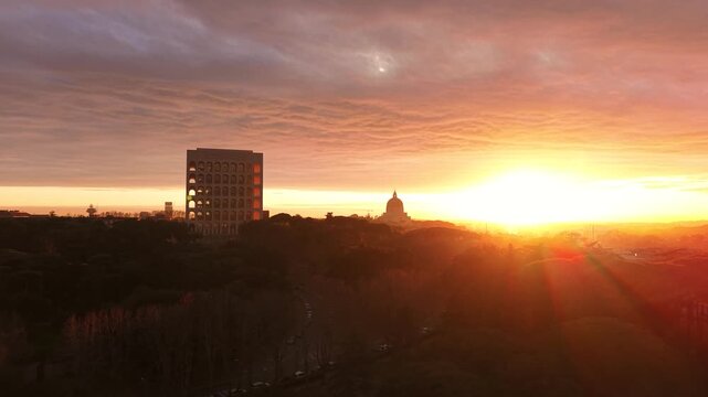 Aerial view of the Palazzo della Civilt&agrave; Italiana (Square Colosseum) at golden hour sunset. Drone flight over the EUR district in Rome, Italy, featuring rationalist architecture.