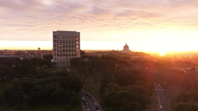 Aerial view of the Palazzo della Civilt&agrave; Italiana (Square Colosseum) at golden hour sunset. Drone flight over the EUR district in Rome, Italy, featuring rationalist architecture.