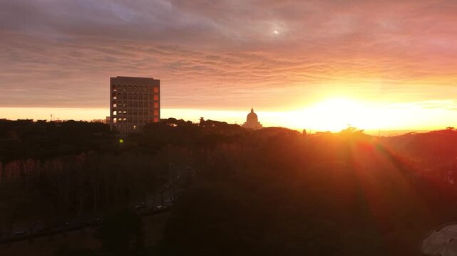 Aerial view of the Palazzo della Civilt&agrave; Italiana (Square Colosseum) at golden hour sunset. Drone flight over the EUR district in Rome, Italy, featuring rationalist architecture.
